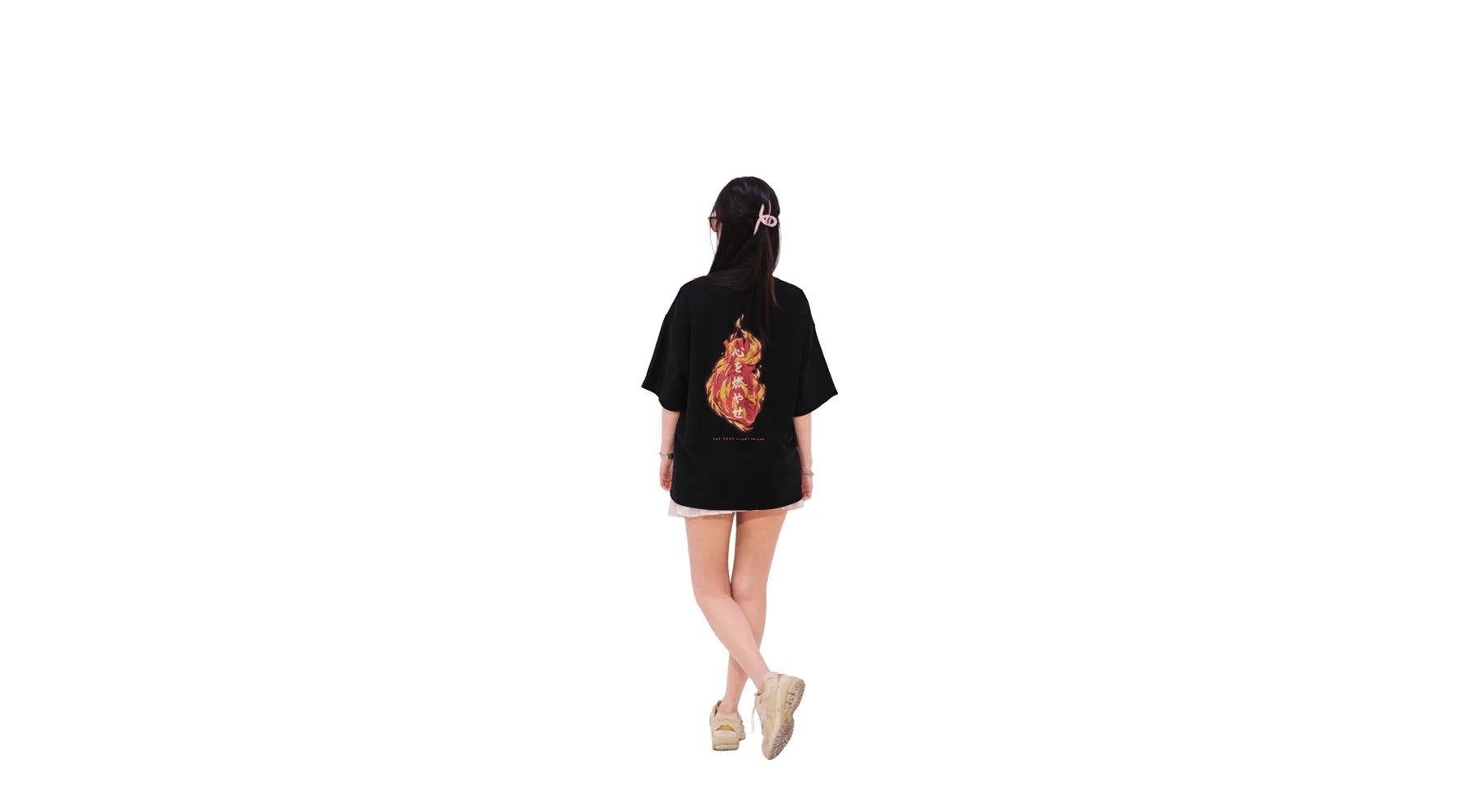 Back view of oversized black NO1 Apparels anime t-shirt, subtle anime merch featuring Set your Heart Ablaze motif, inspired by Rengoku, worn by female model.