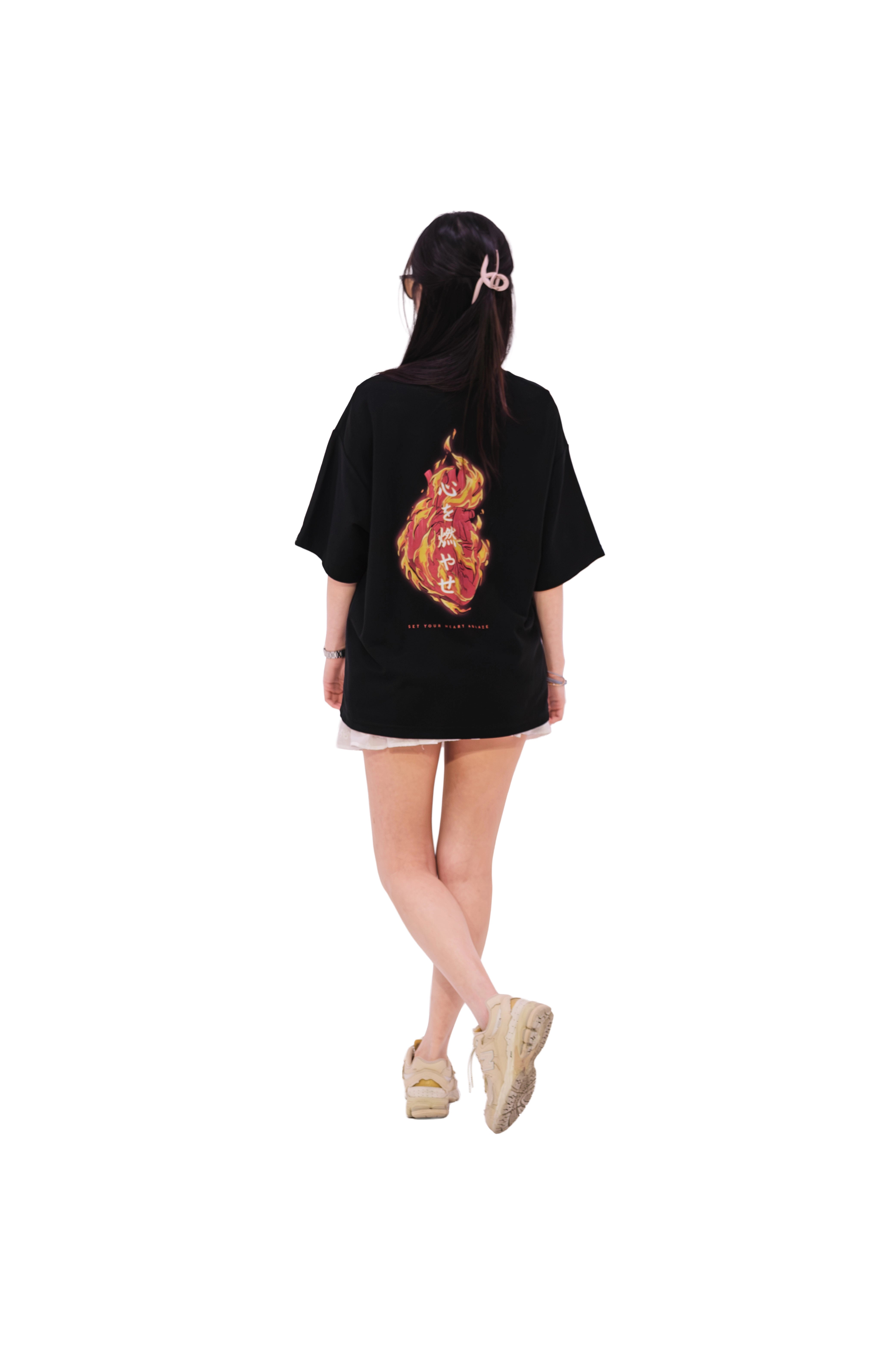Back view of oversized black NO1 Apparels anime t-shirt, subtle anime merch featuring Set your Heart Ablaze motif, inspired by Rengoku, worn by female model.