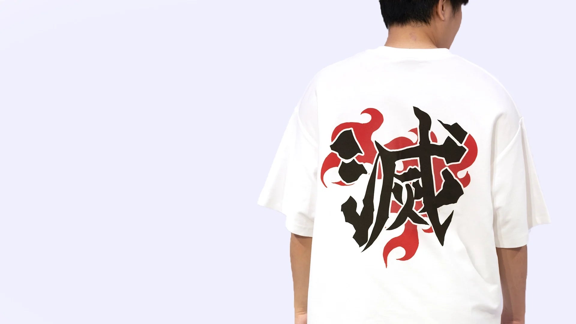 Back view of oversized white NO1 Apparels anime t-shirt, subtle anime streetwear inspired by Demon Slayer, featuring Demon Slayer Corps Uniform, worn by male model.