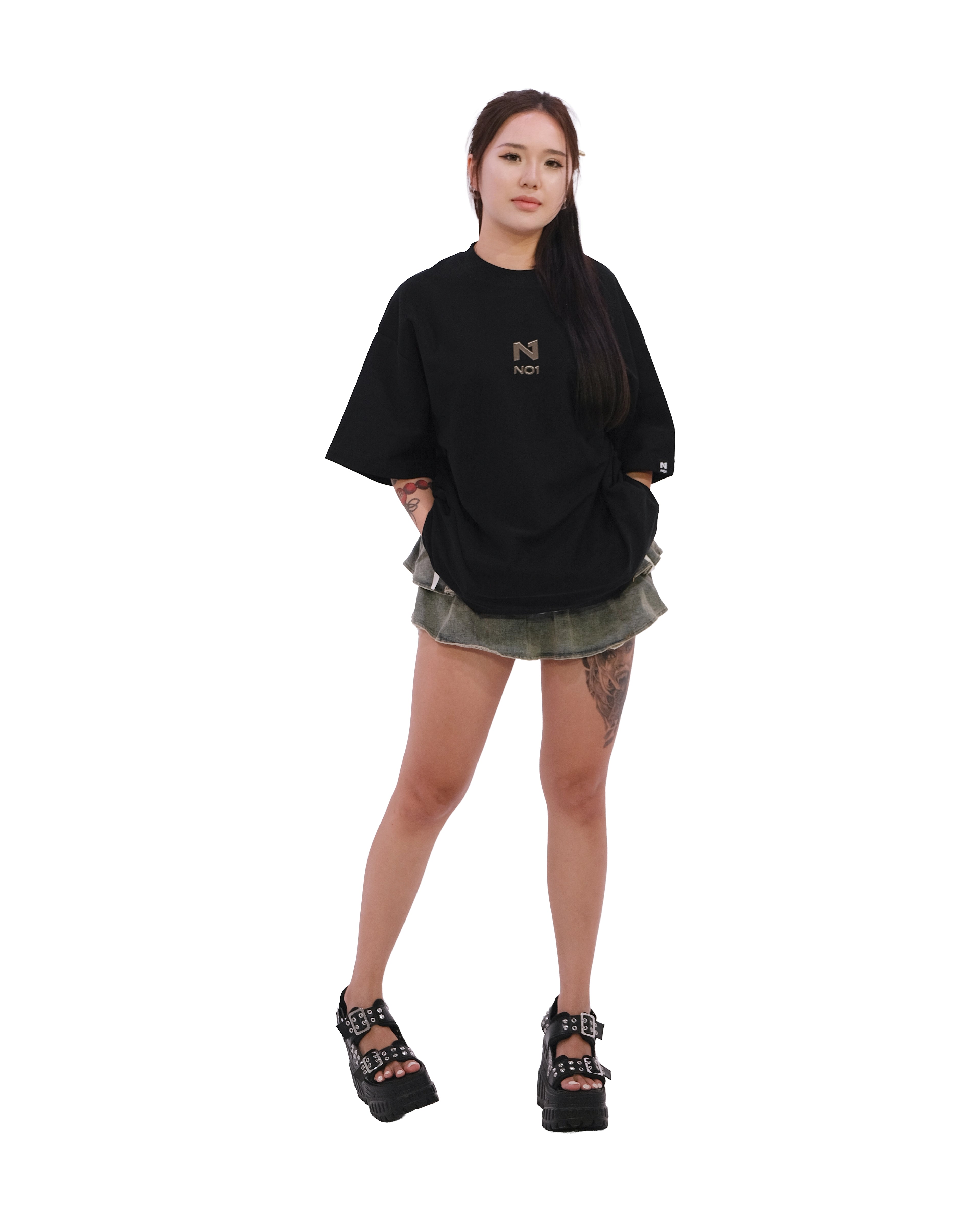 Front view of oversized black NO1 Apparels anime t-shirt, subtle anime clothing inspired by Attack on Titan, Cabin's Kiss design featuring NO1 Logo, worn by female model.