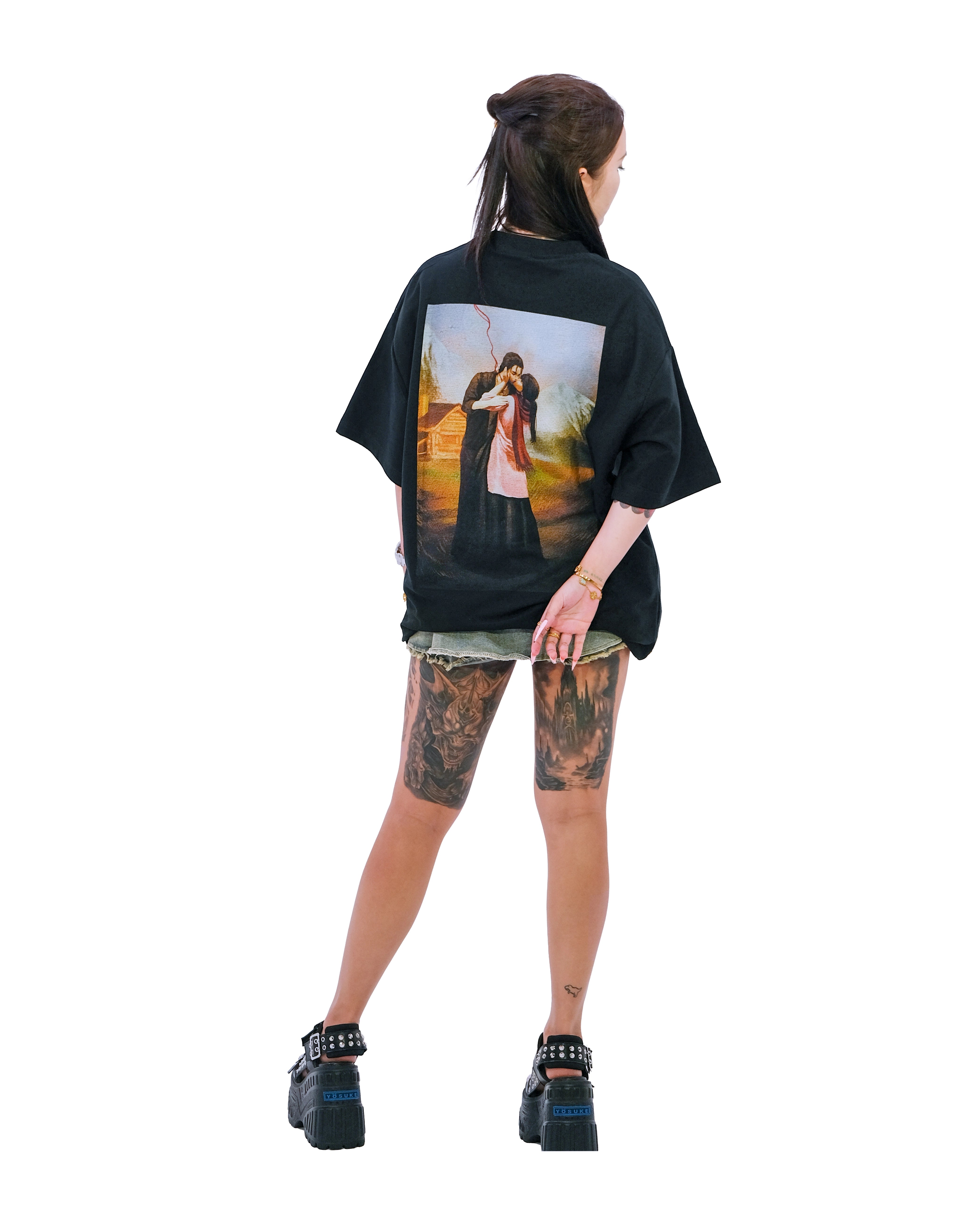 Back view of oversized black NO1 Apparels anime t-shirt, subtle anime clothing inspired by Attack on Titan, Cabin's Kiss design featuring minimalist graphic inspired by Attack on Titan's Cabin Scene, worn by female model.