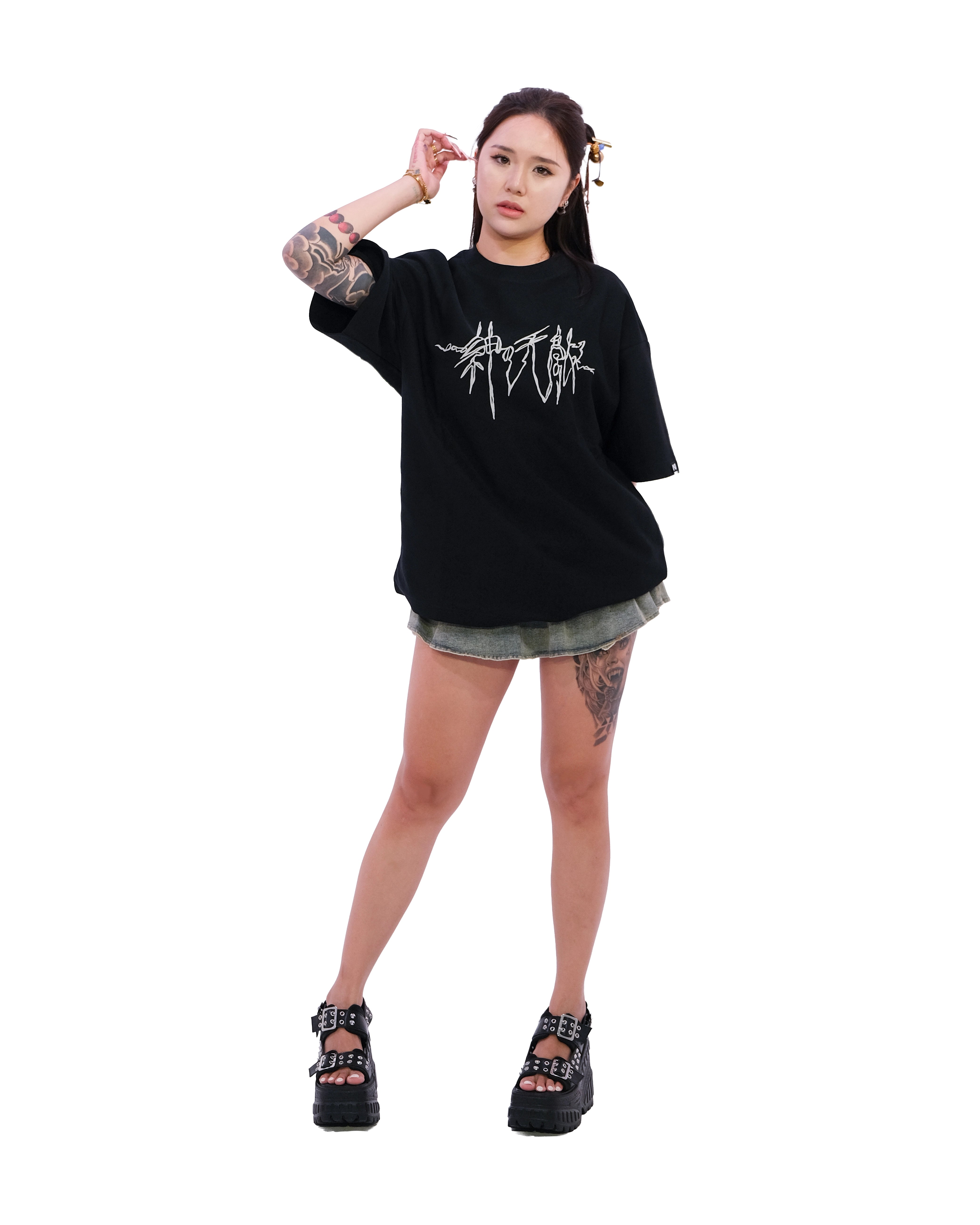 Front view of oversized black NO1 Apparels anime t-shirt, subtle anime clothing inspired by One Piece, Enemies of the Gods design featuring minimalist graphic inspired by Will of D, worn by female model.