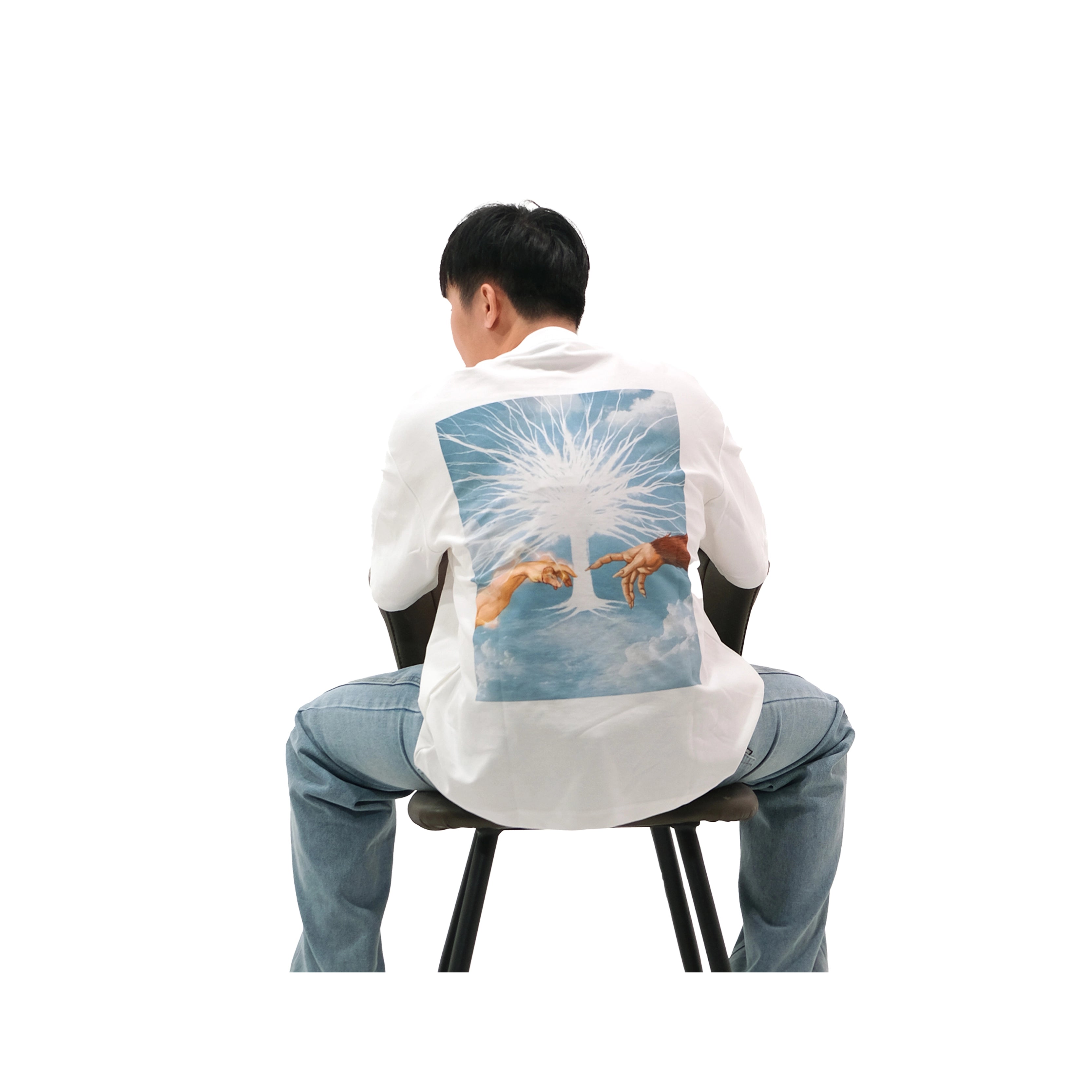 Male model wearing white oversized anime t-shirt, Creation of Attack on Titan design with Paths Tree and hand illustration inspired by Creation of Adam.